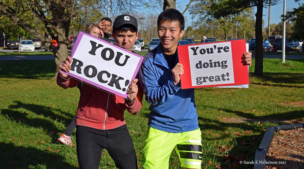 graduate students cheer runners