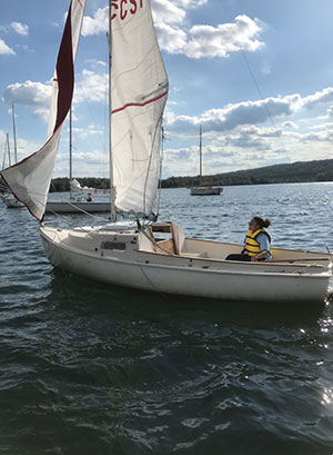 Danielle Frye in a sailboat on Cayuga Lake