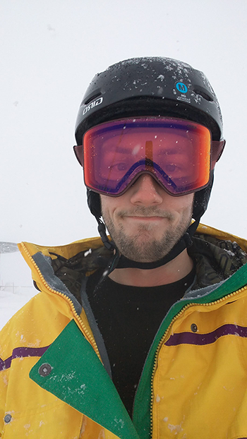 Jordan McMahan dressed in coat and goggles for winter snowboarding