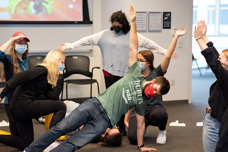 students build a human structure in the improv workshop