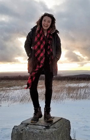 Cassie Gologorsky standing at sunset at the cornell observatory