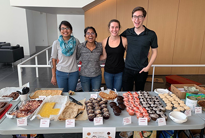 The Lammerding Lab hosting their annual bake sale to fundraise for the Ithaca Cancer Resource Center in 2019. From left: Pragya Shah, Richa Agrawal, Melanie Wallace, and Joseph Long.