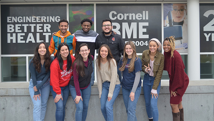Members of the 2023 Cornell BMES Board standing together in front of Weill Hall
