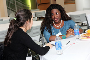 Liz Wayne, right, a Cornell graduate student in biomedical engineering, offers advice to a conference participant.