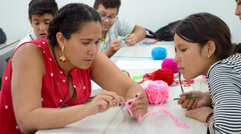 Ana Maria Porras with student crocheting