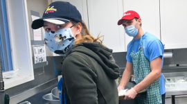 Karinna Browning ’17, a major gifts associate in Alumni Affairs and Development, and Grant Rowlands, a Ph.D. candidate in biomedical engineering, clean dishes in the kitchen at Loaves & Fishes.