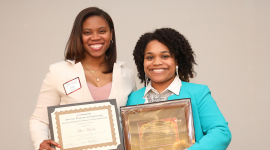 Students Tibra Wheeler and Monet Roberts with awards