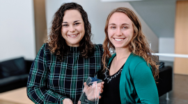 Haley Antoine (left) and Carolyn Chlebek (right) holding the award