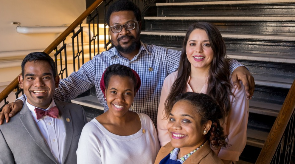five student awardees standing together on stairs