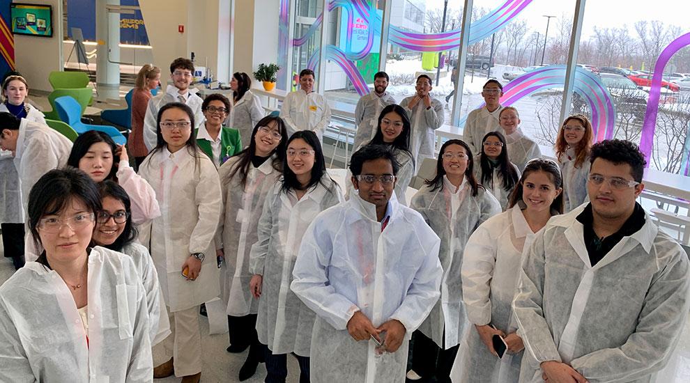 group of students standing in company lab