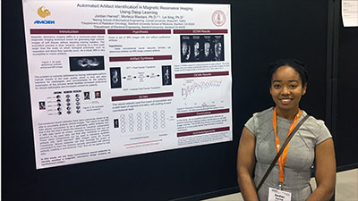 Jordan Harrod in front of her research poster at BMES 2017